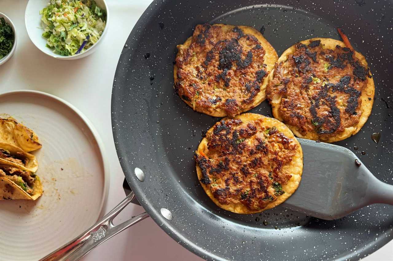 Frying egg roll tacos in a skillet.