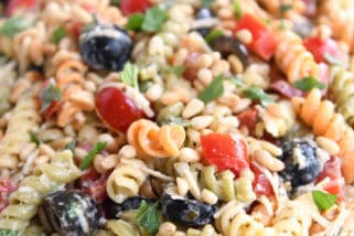 Tri-color pasta salad on white platter.