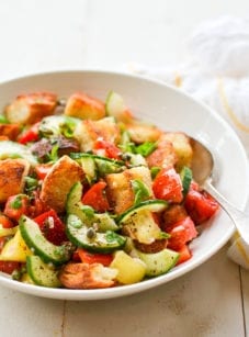 Spoon in a bowl of panzanella salad.