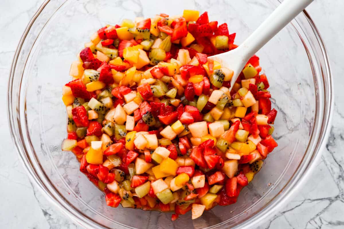 Vibrant fruit salsa is a fresh, juicy twist on your favorite snack! Sweet berries, tropical mango, and a splash of lime always steal the spotlight! Especially when served with crispy cinnamon chips! Raspberry jam mixed in with the diced fruit.