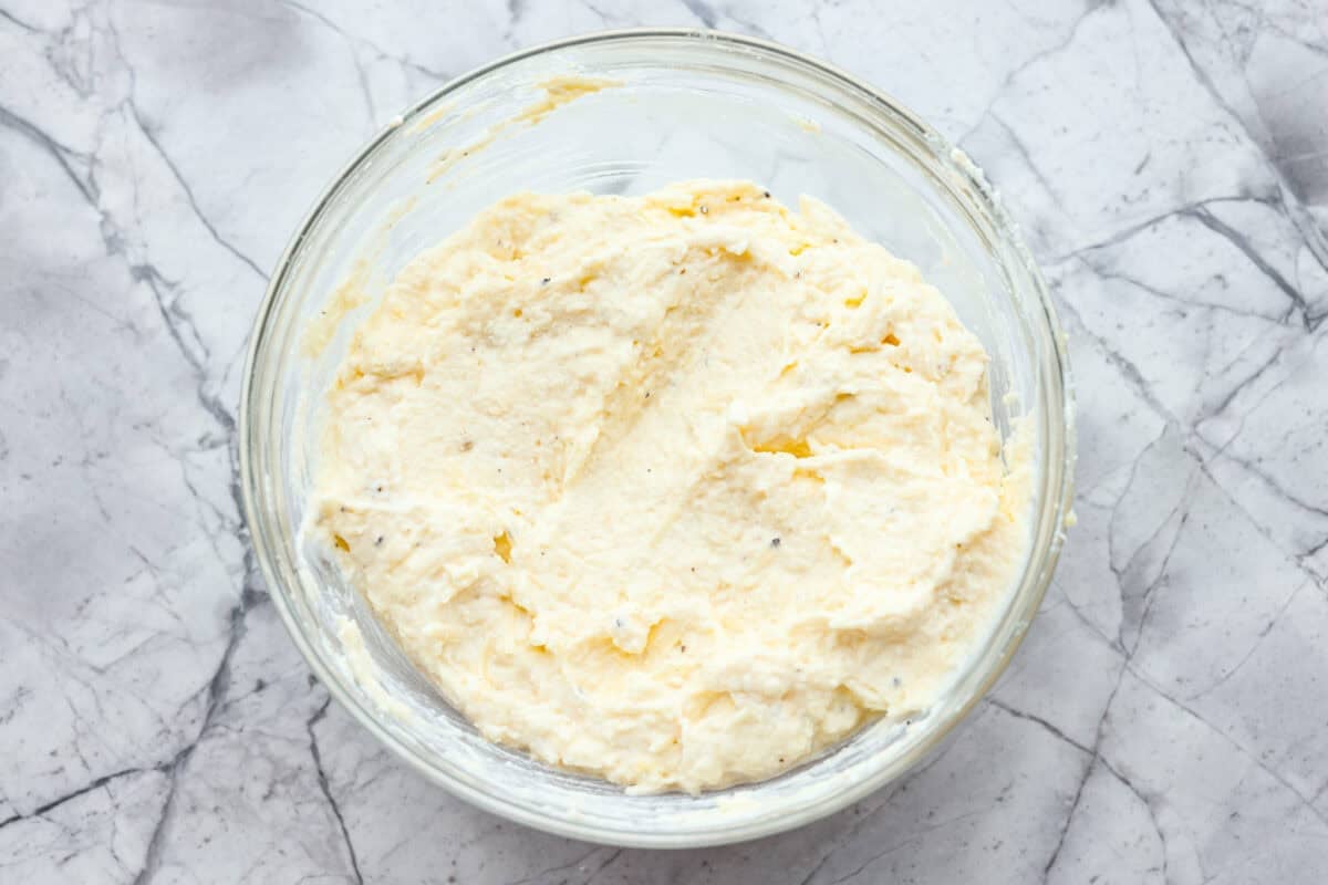 They don’t call it Marry Me Lasagna for nothing! One bite of the creamy sauce, tender chicken, and melty cheese, and everyone will be saying, Ricotta cheese, parmesan, egg, salt, and pepper mixed together in a bowl.