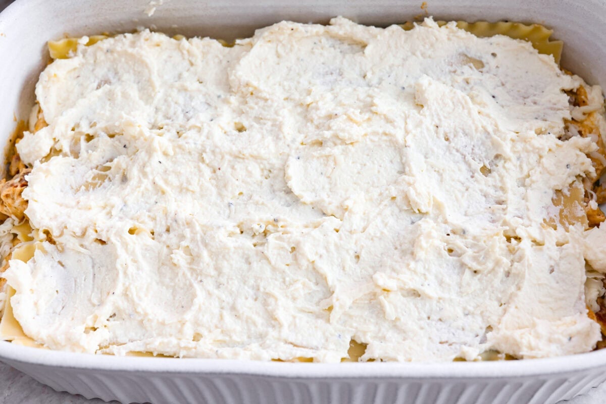 They don’t call it Marry Me Lasagna for nothing! One bite of the creamy sauce, tender chicken, and melty cheese, and everyone will be saying, Ricotta cheese layer on top of the noodles.