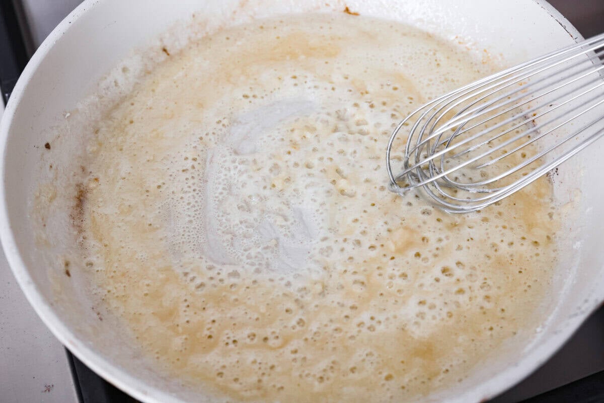 They don’t call it Marry Me Lasagna for nothing! One bite of the creamy sauce, tender chicken, and melty cheese, and everyone will be saying, Melted butter, garlic and flour being whisked together to create a roux.