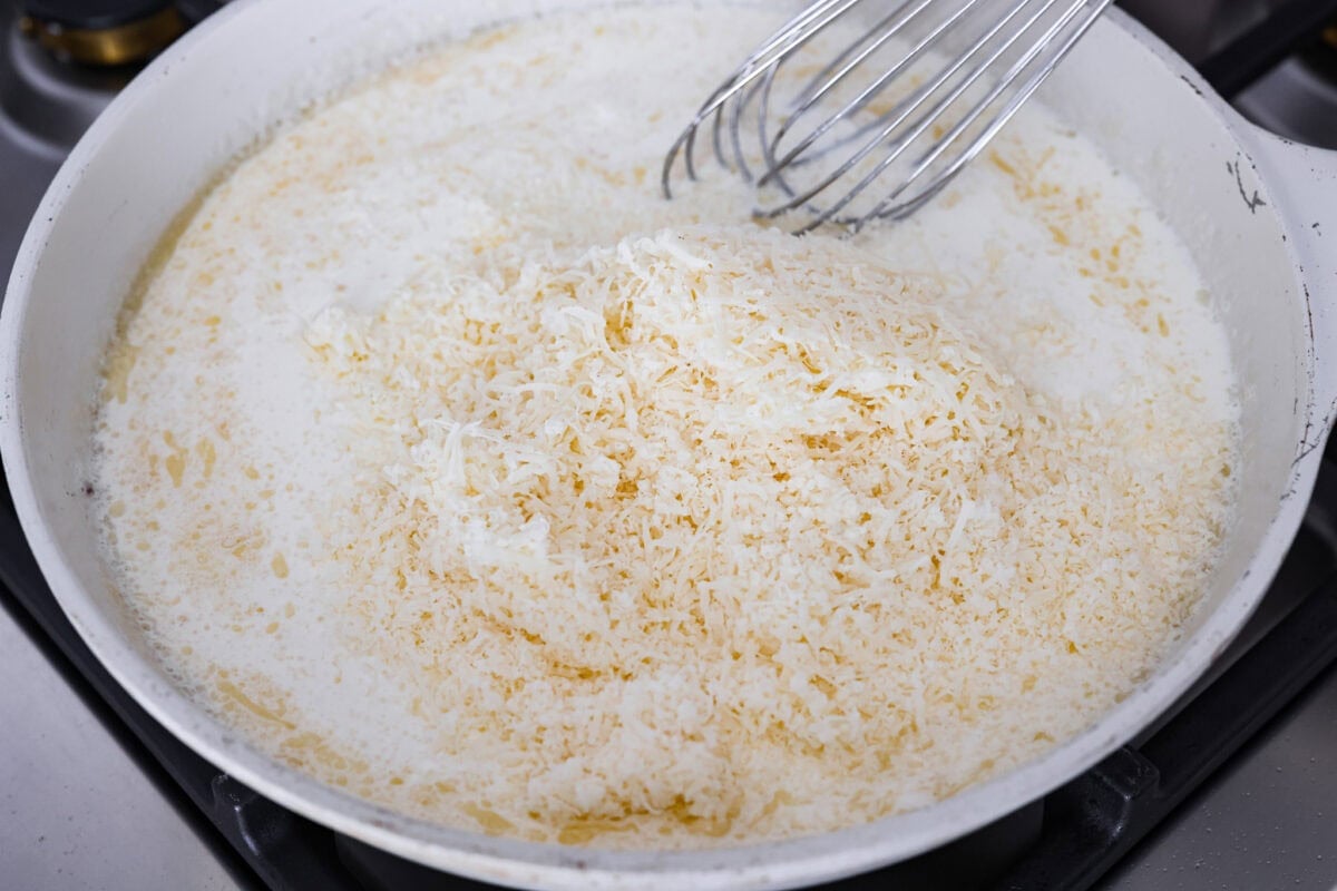They don’t call it Marry Me Lasagna for nothing! One bite of the creamy sauce, tender chicken, and melty cheese, and everyone will be saying, Chicken broth, heavy cream and grated parmesan cheese added to the roux to make the cream sauce.
