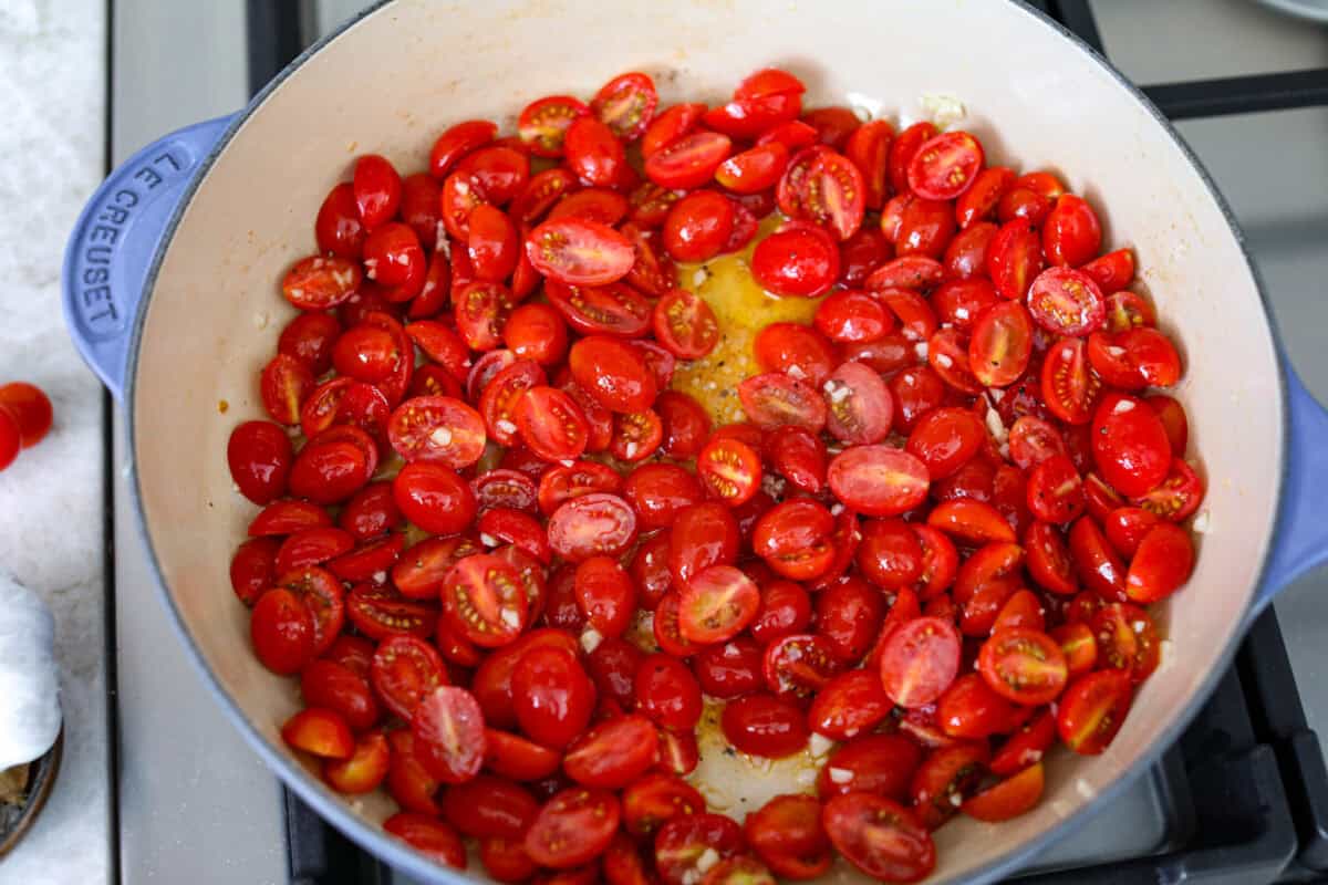 Cherry tomatoes cooking in olive oil and garlic. 