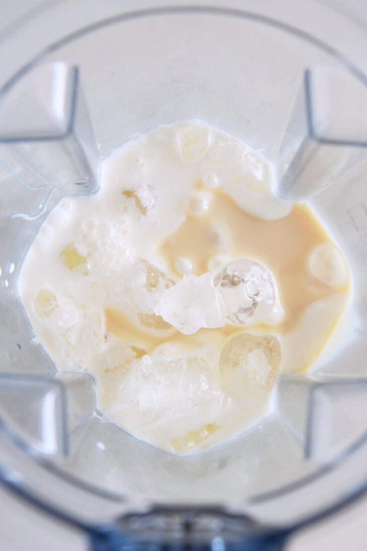 Blender filled with ice, sweetened condensed milk, fresh lemon juice and heavy cream.