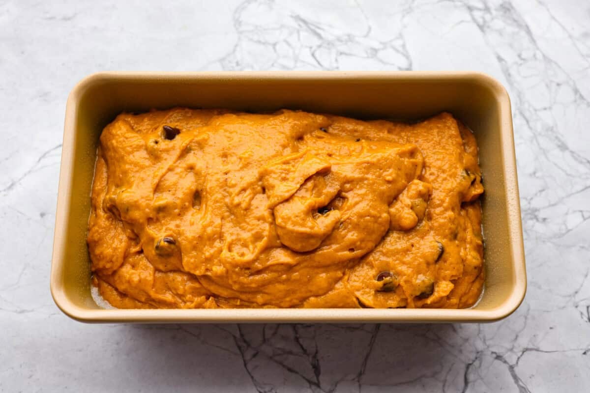 Bread batter in the loaf pan. 