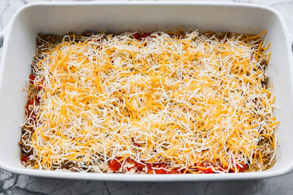 Everything mixed together and topped with cheese. 