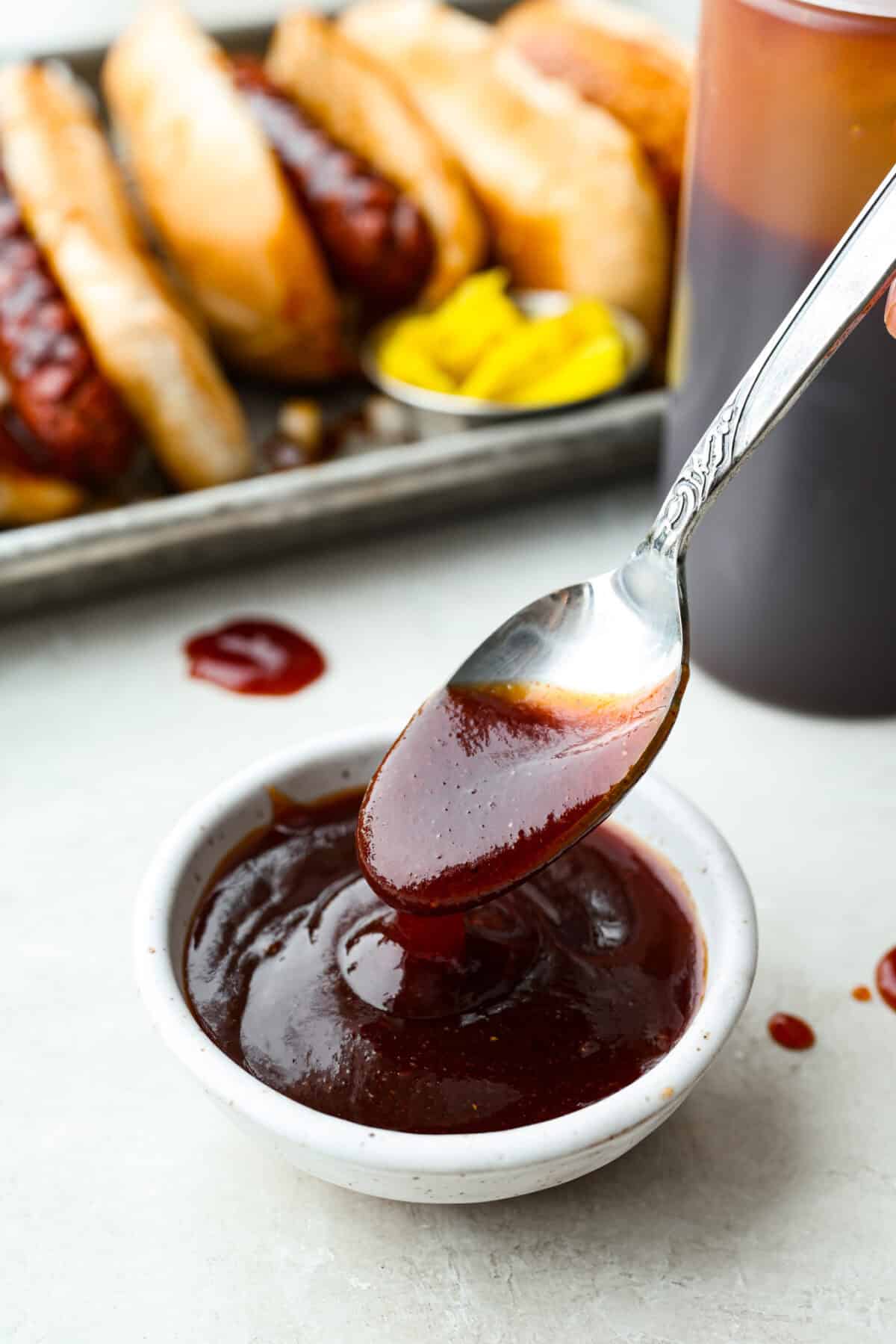 Small bowl of J Dawgs sauce with a spoon. 