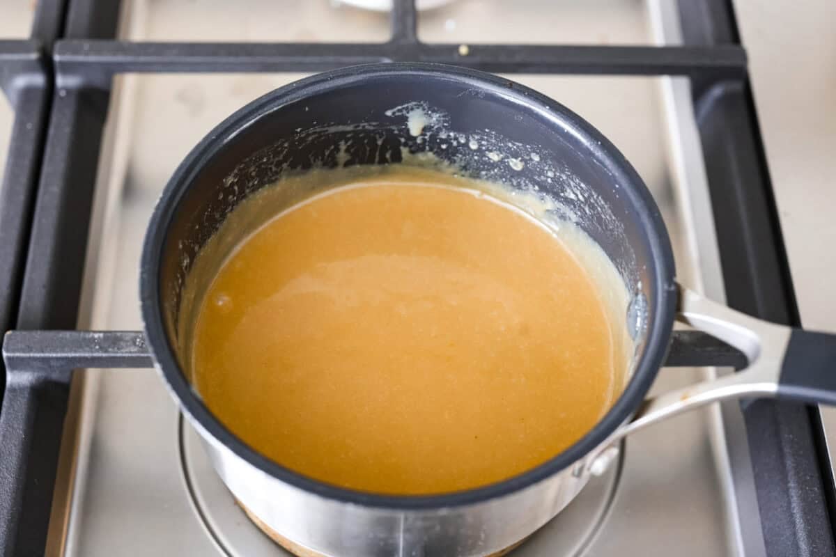 Caramel apple cinnamon roll glaze in a pan. 