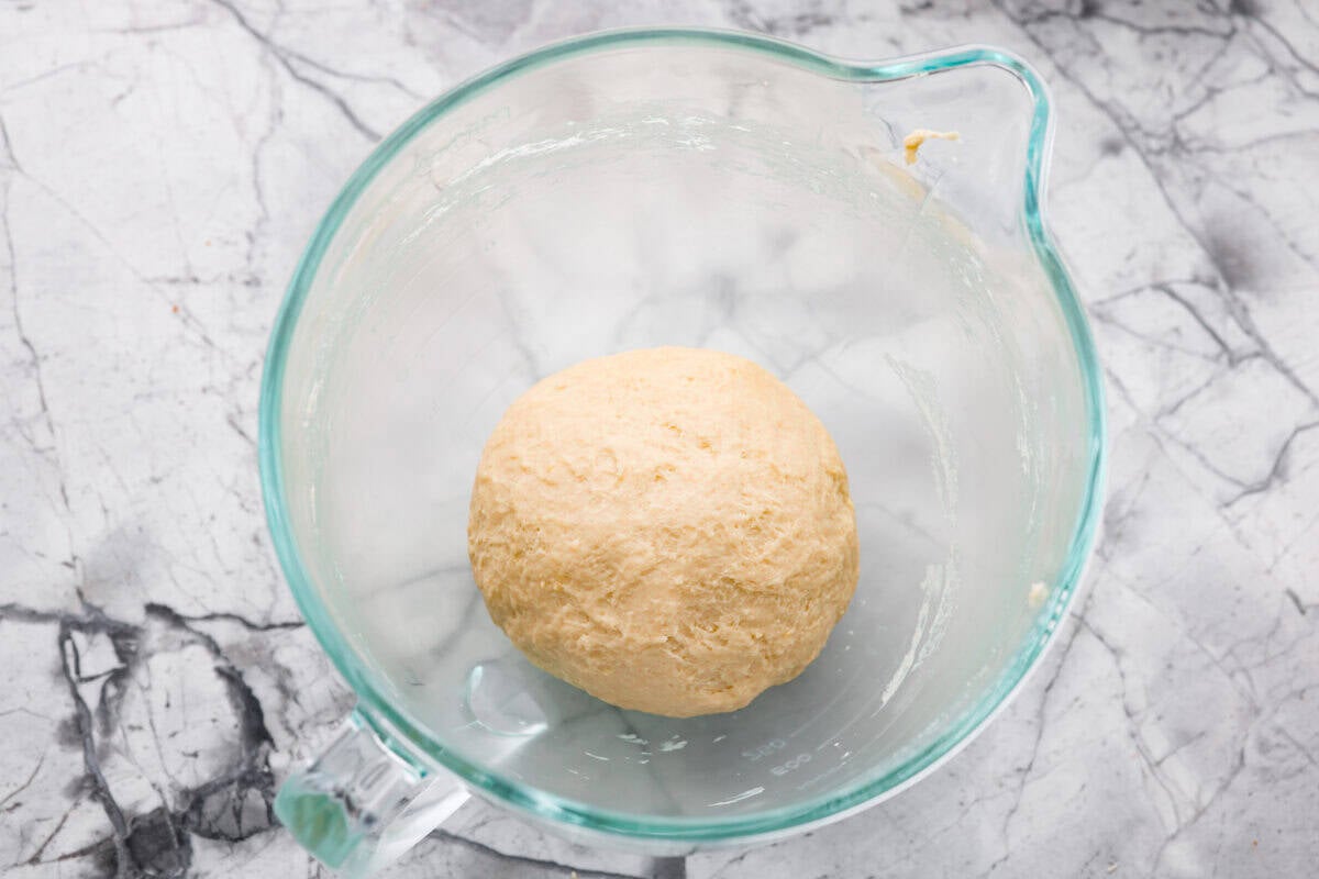 Egg and milk added to the dry ingredients to make ball of dough. 