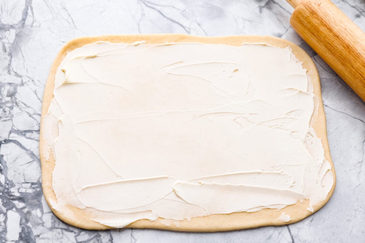 Rolled out dough covered in butter.