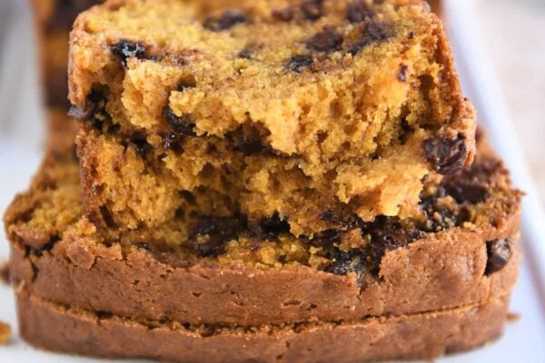 Two half slices of pumpkin chocolate chip bread.