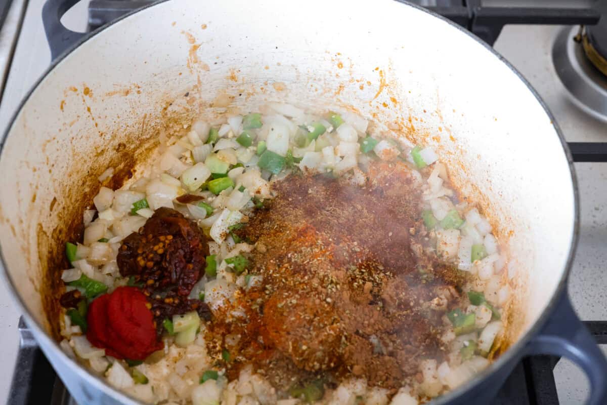 Spices and seasonings added to the onion mixture in the dutch oven.