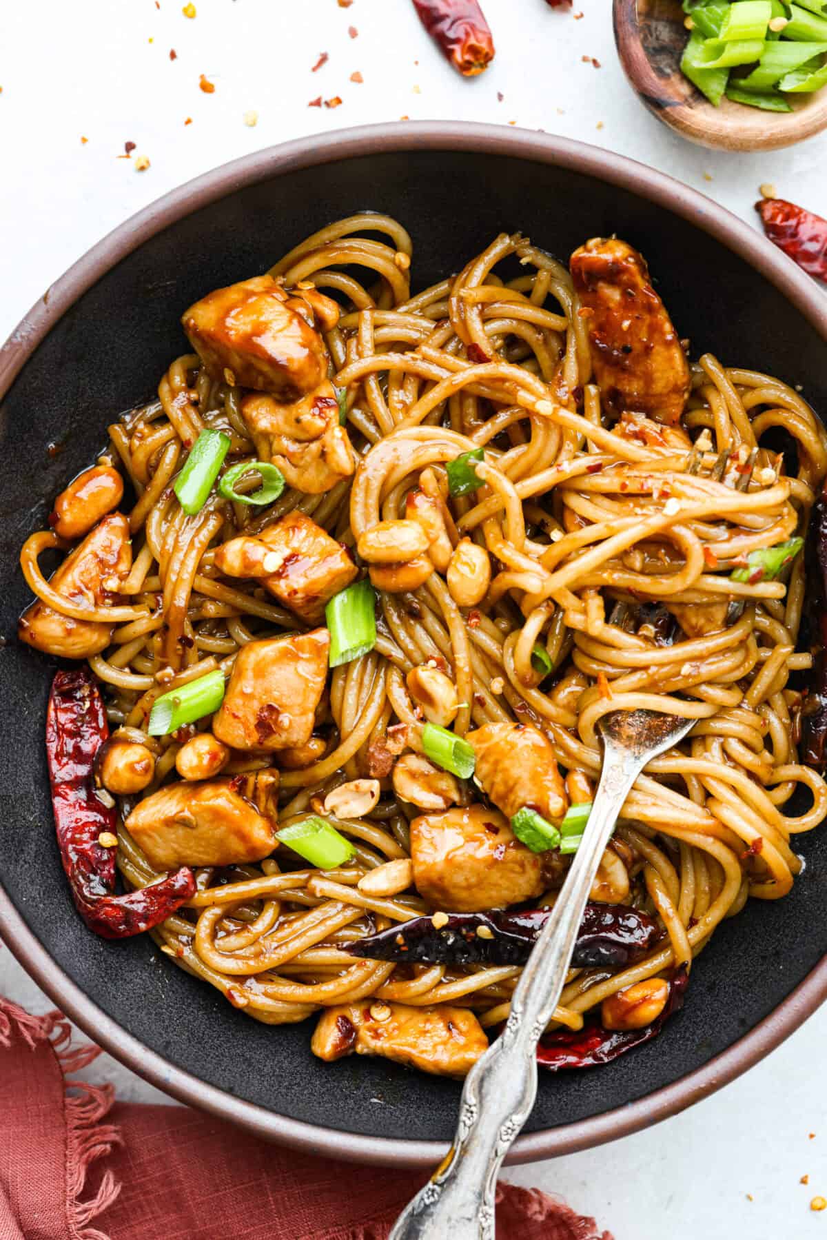 Serving bowl of Kung Pao chicken noodles. 