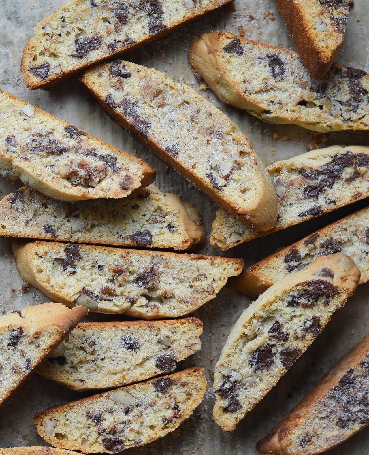 Slices of chocolate chip Mandel bread on parchment paper.