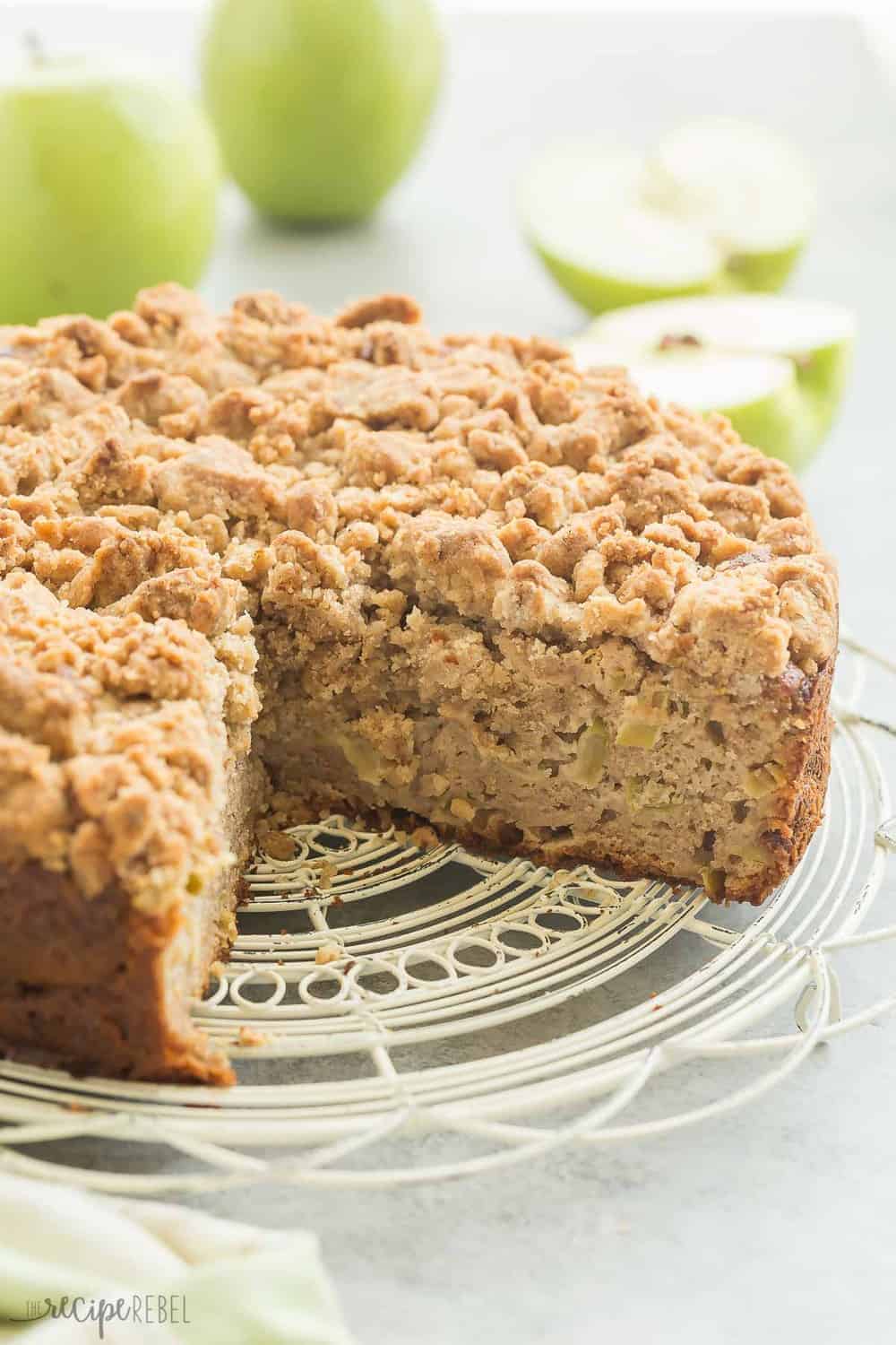 This Crumb-Topped Apple Coffee Cake is perfect for fall! Greek yogurt and extra apples keep it moist and a crunchy crumb topping gives it extra decadence!