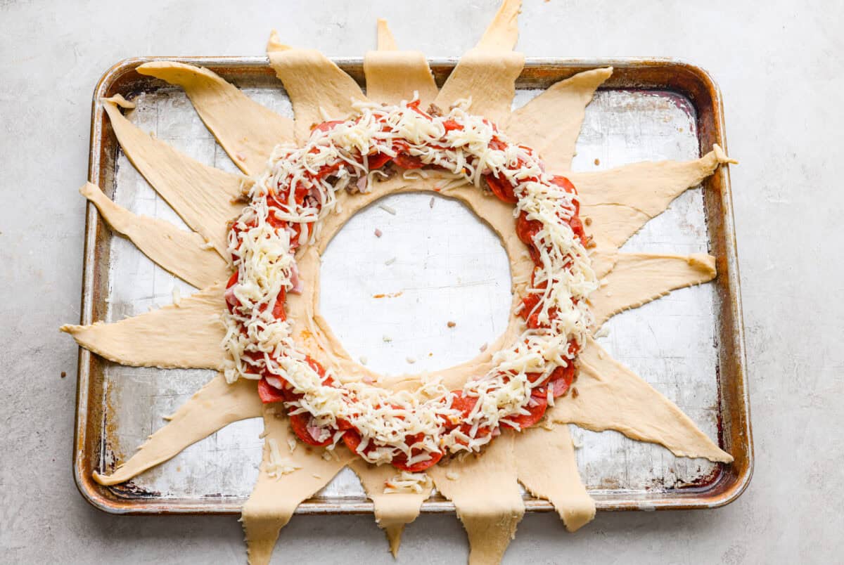 Cheese sprinkled over the top of the toppings. 