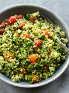 Spoon in a bowl of tabbouleh.