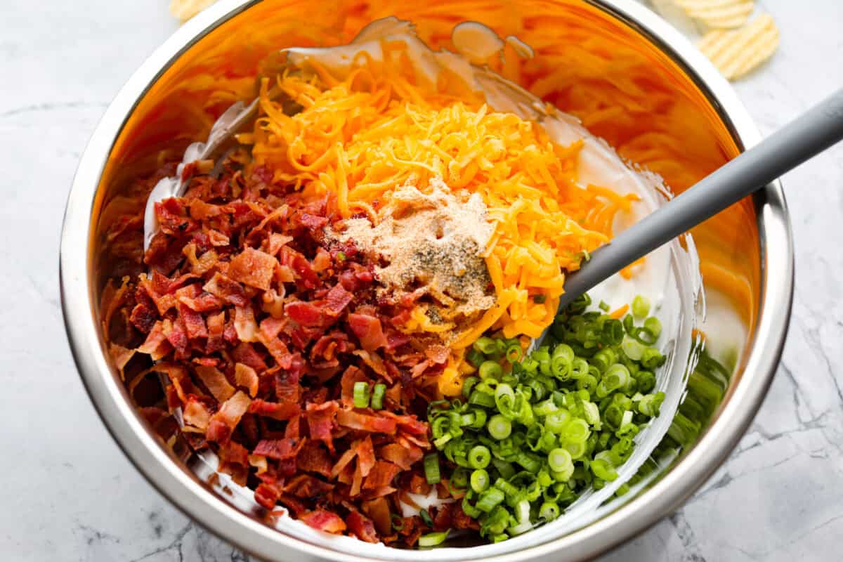 Cheese, bacon, onions, garlic powder, salt, and pepper added to the cream cheese mixture.