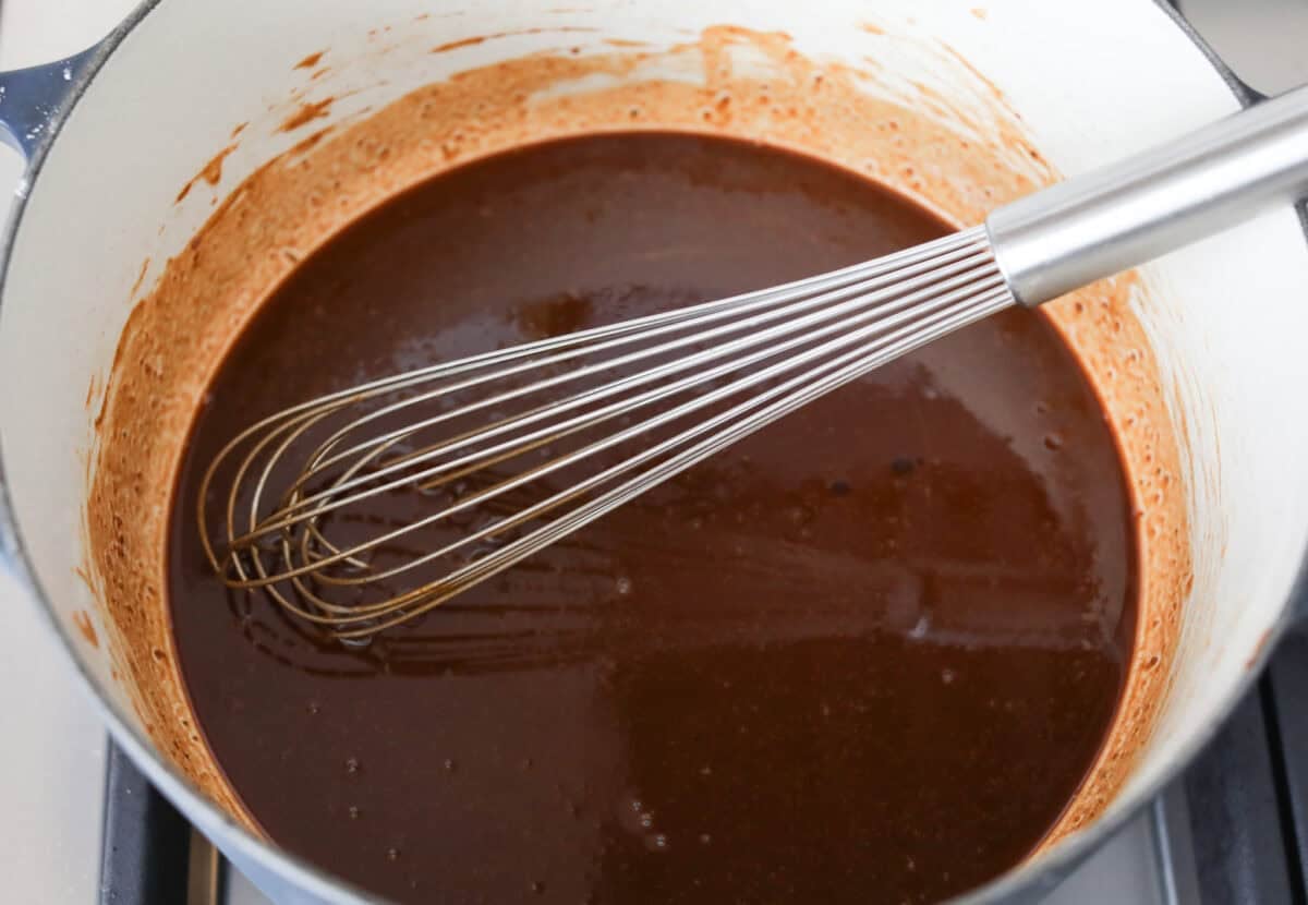 Pot of dark roux and a whisk.