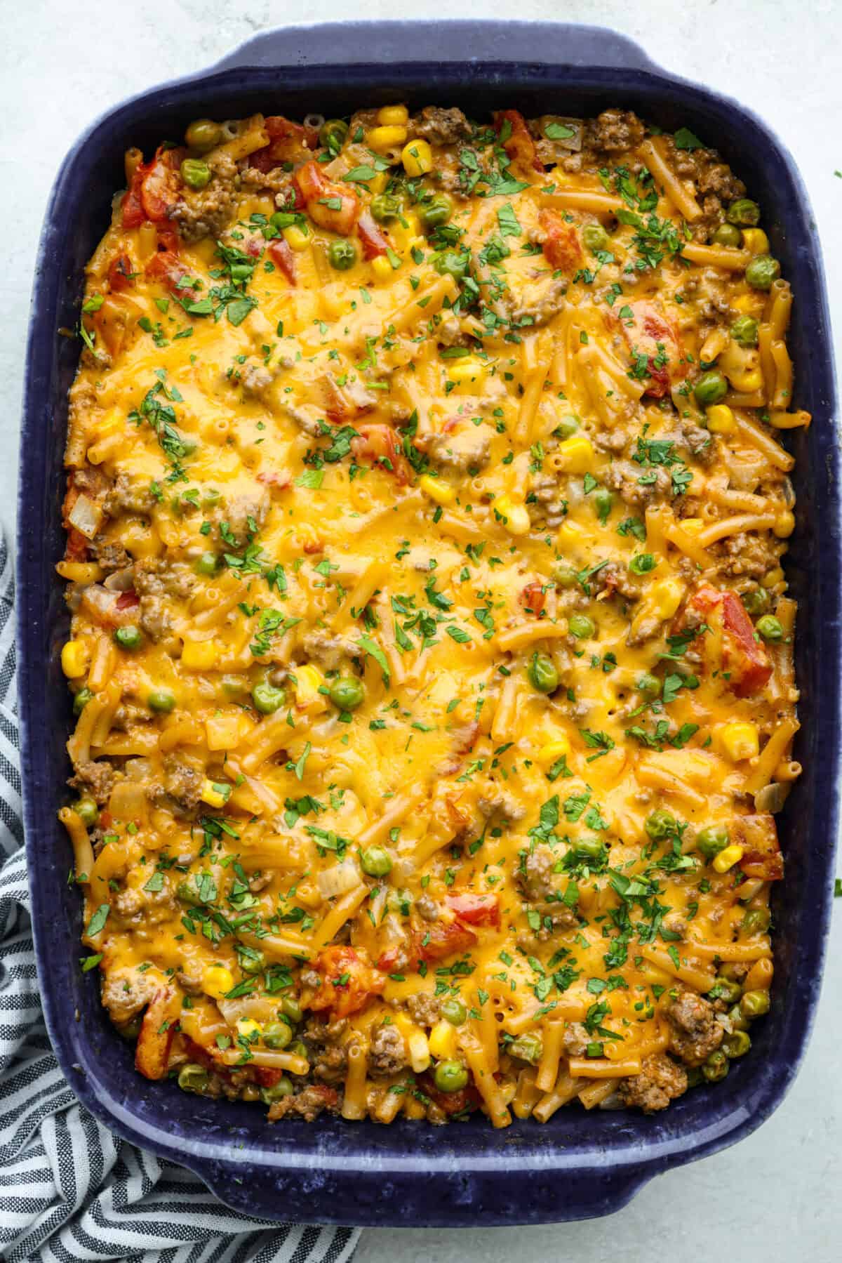 Shipwreck casserole is the ultimate “use what you’ve got” comfort food! Layer it with rice, potatoes, or pasta, toss in any veggies on hand, and make it as cheesy as you like. It’s hearty, budget-friendly, and nearly impossible to mess up! Overhead shot of baked and ready to eat shipwreck casserole in a baking dish.