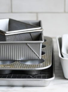 Pile of pans on a counter.