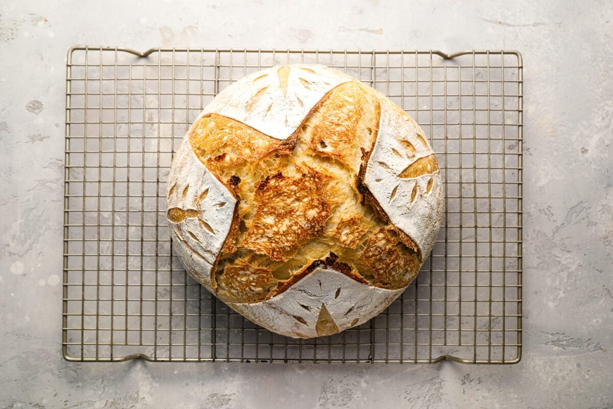 sourdough loaf cooling on wire rack