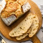 slices of sourdough bread laying next to remainder of loaf
