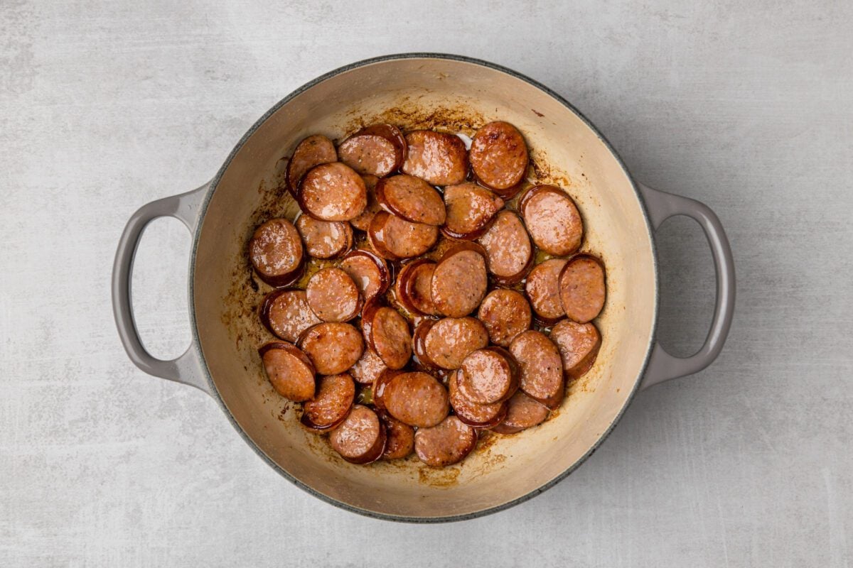 dutch oven with browned andoullie sausage