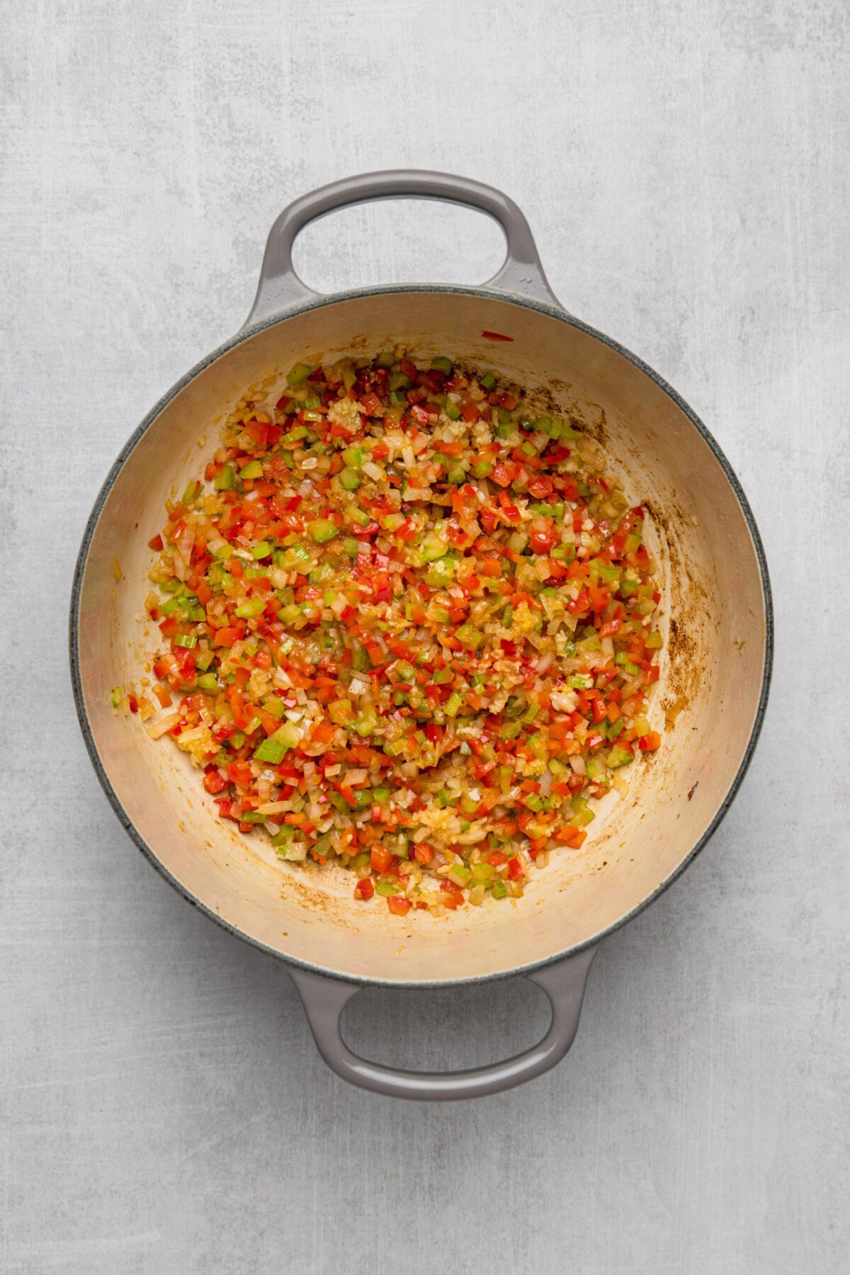 uncooked onion, celery, bell pepper, and garlic in dutch oven