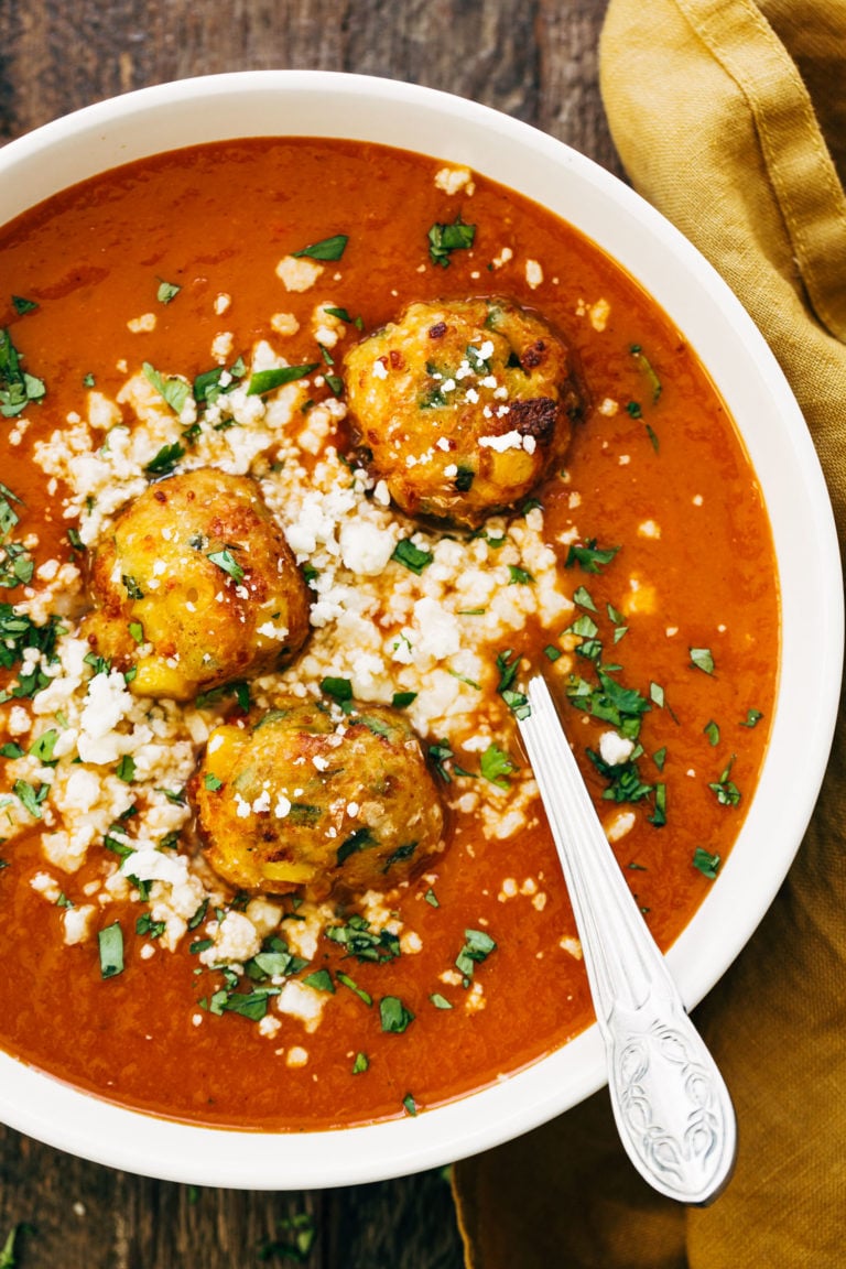 Sopa tarasca in a bowl topped with corn fritters.