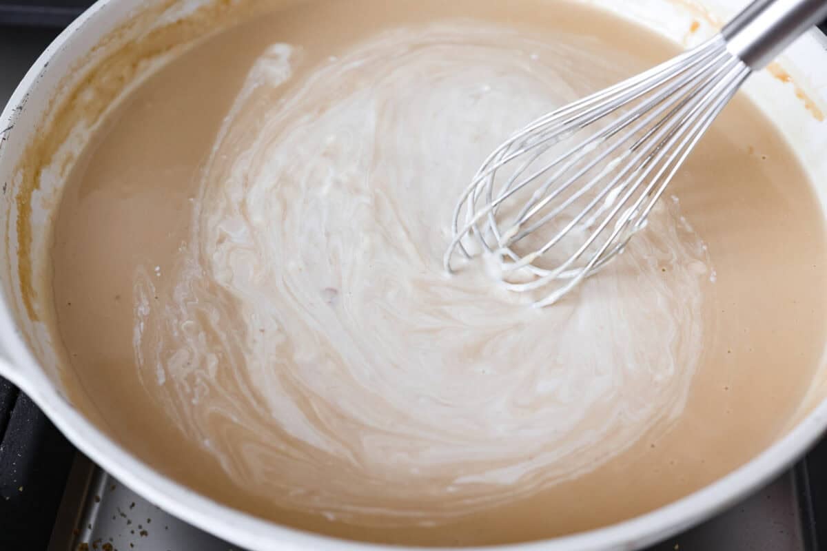 Pan removed from heat and sour cream added to sauce and whisked in. 