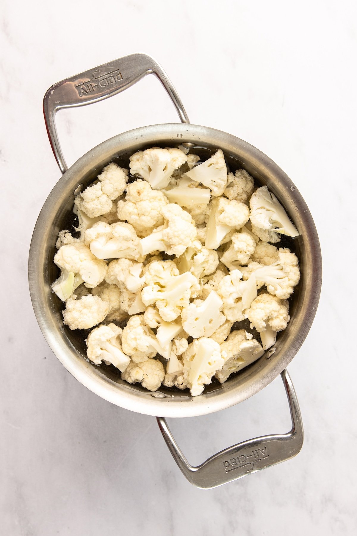large pot with cauliflower cooking in water