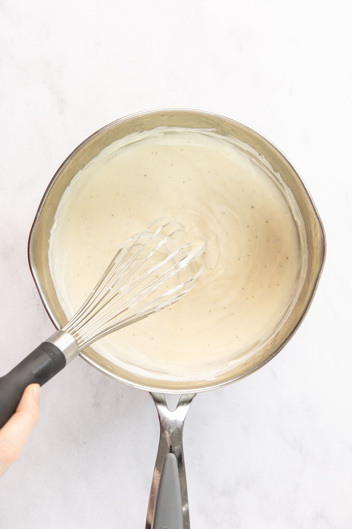 prepared bechamel sauce in medium saucepan