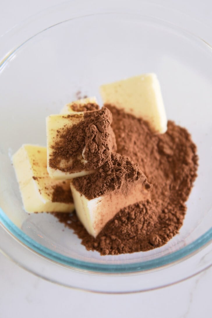 Glass bowl with butter and cocoa powder.