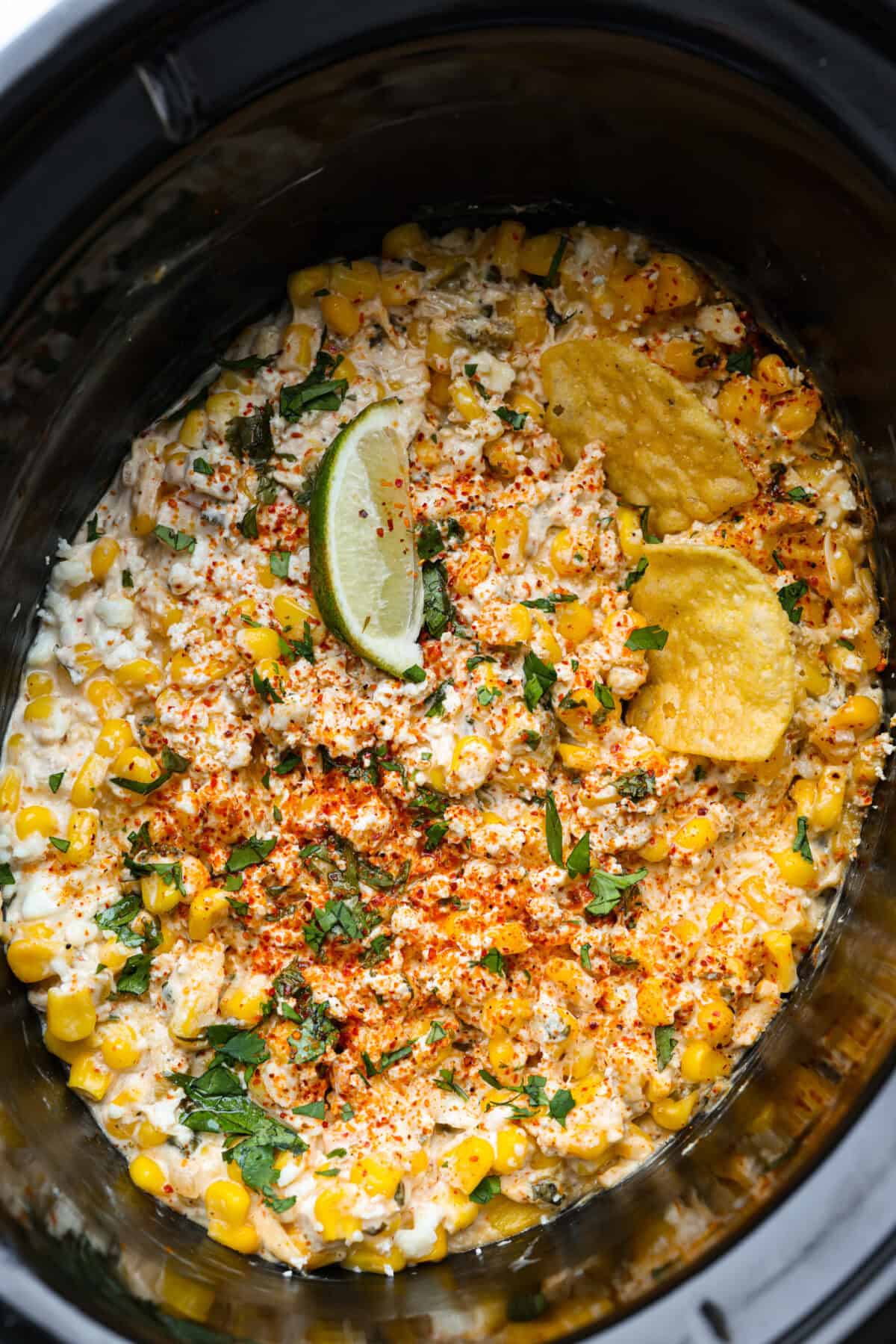 Overhead shot of Mexican street corn dip in a slow cooker.
