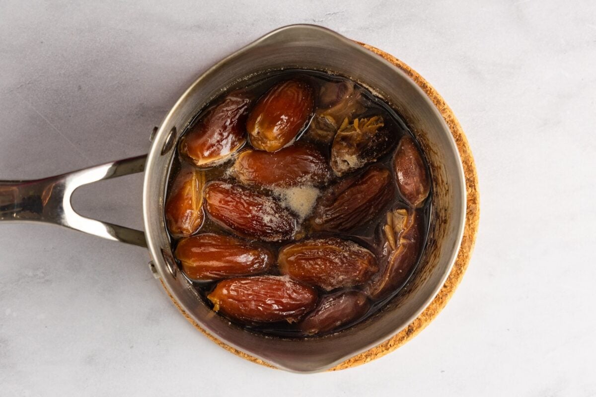 dates soaking in boiling hot water in pot