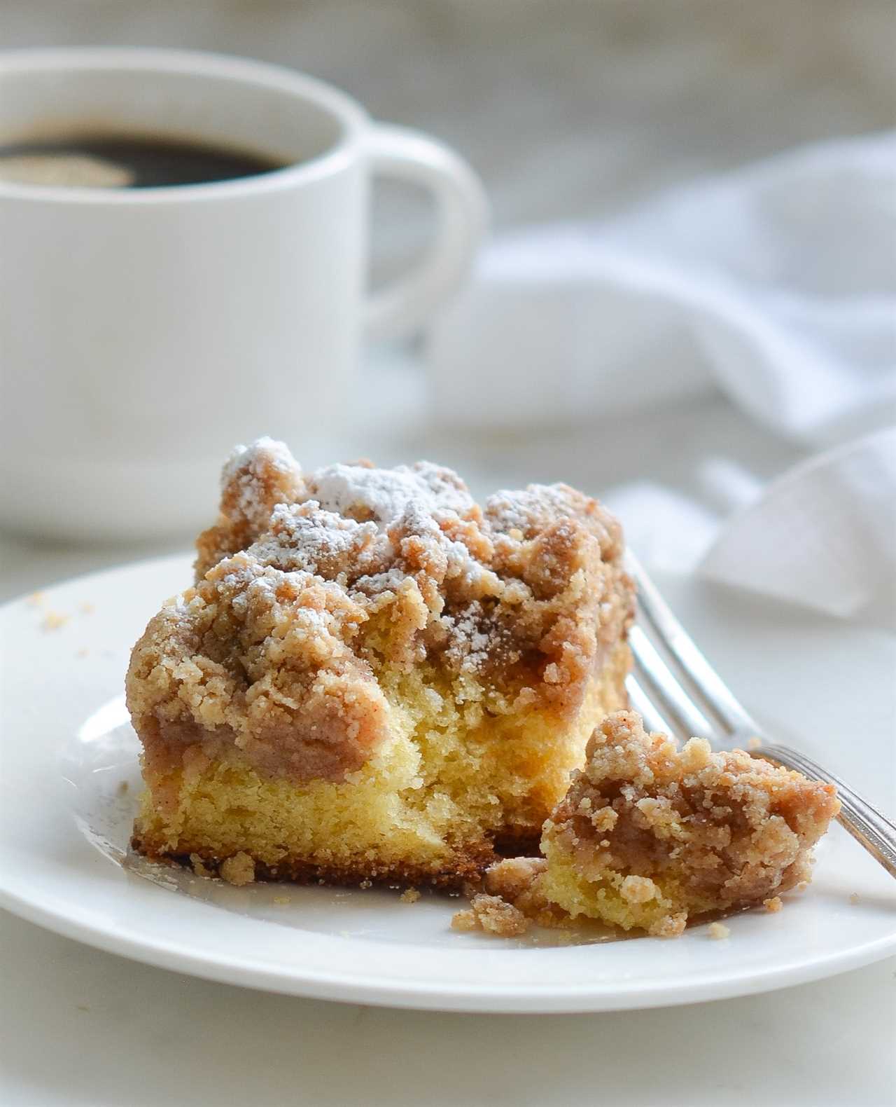 Piece of crumb cake on a plate.