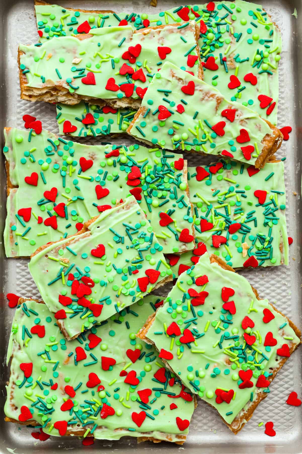 Overhead shot of Grinch Christmas crack broken into pieces.