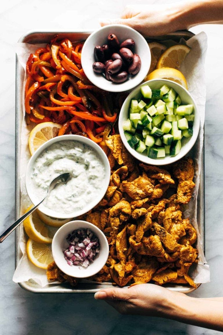 Sheet pan chicken and peppers with toppings.