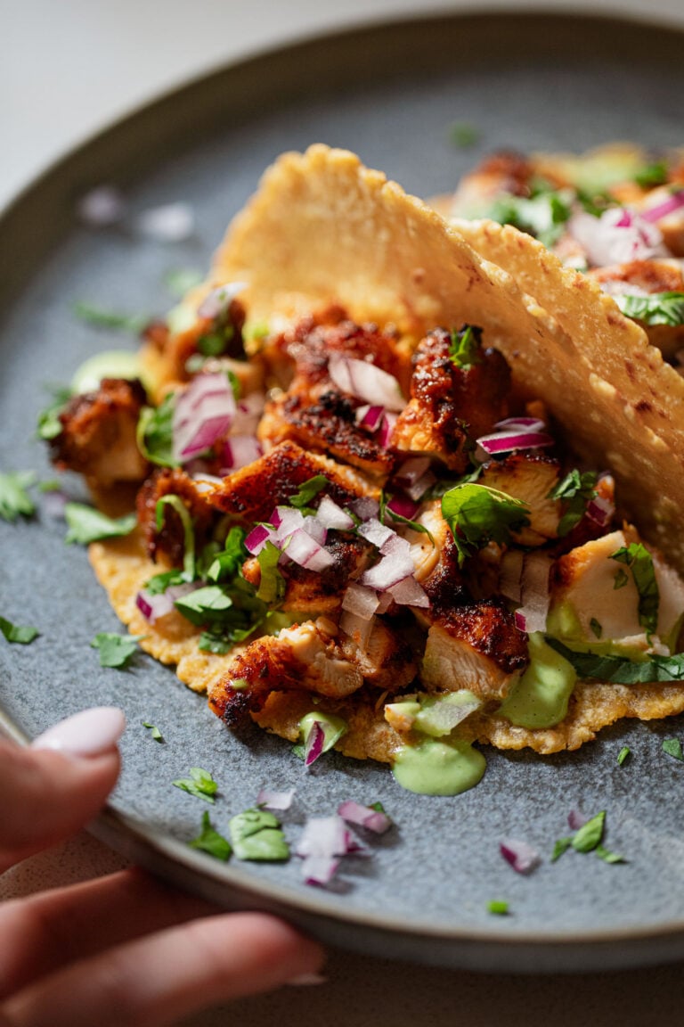 Tacos with red onion and green sauce.