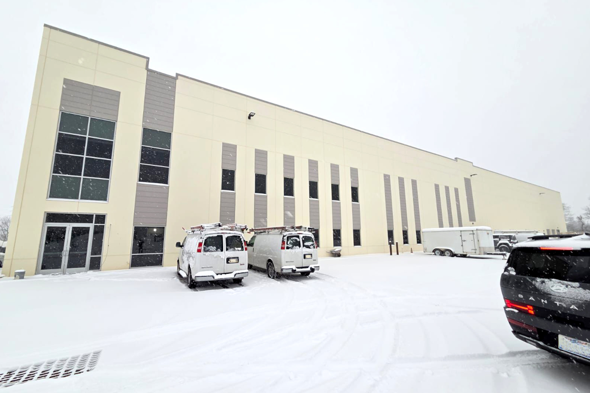 Il Pastaio US plant in the United States. Exterior view of the pasta factory in winter with snow, vans, and a trailer.