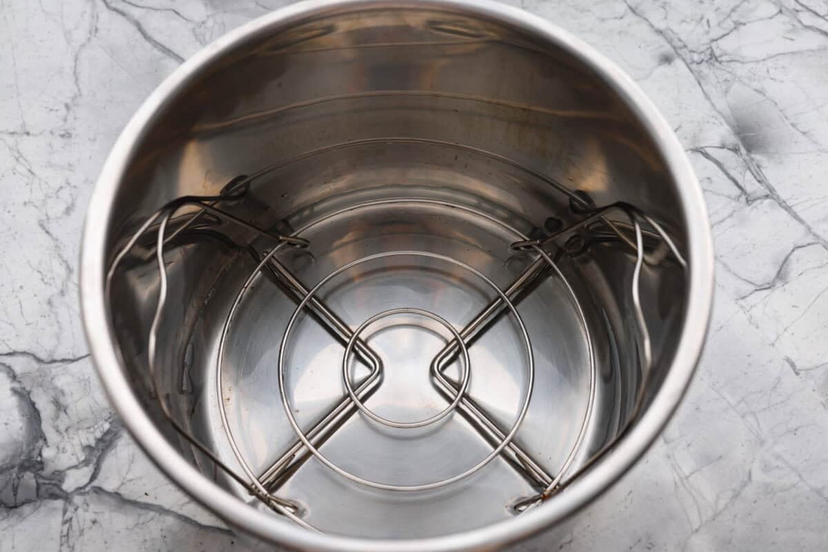 Instant pot with trivet and water added to it. 