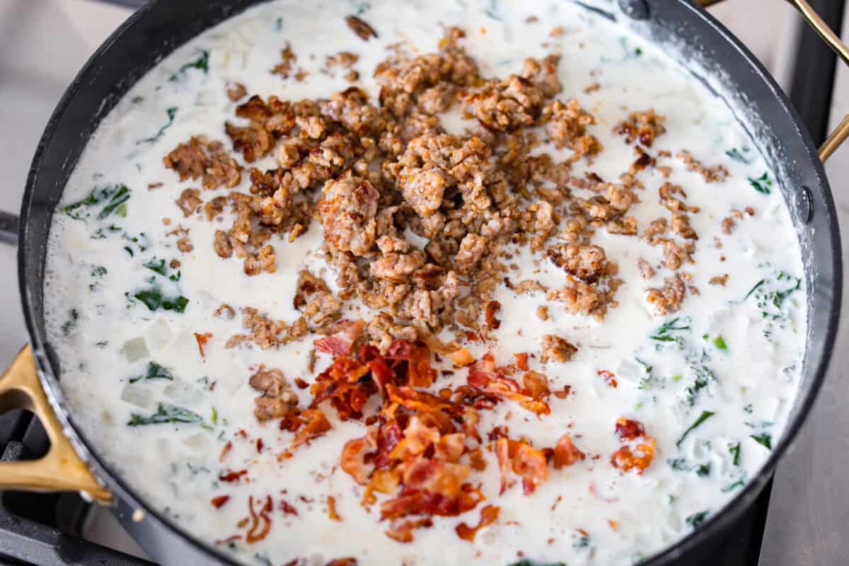 Cream, broth, cheese seasonings and meats added to the skillet.