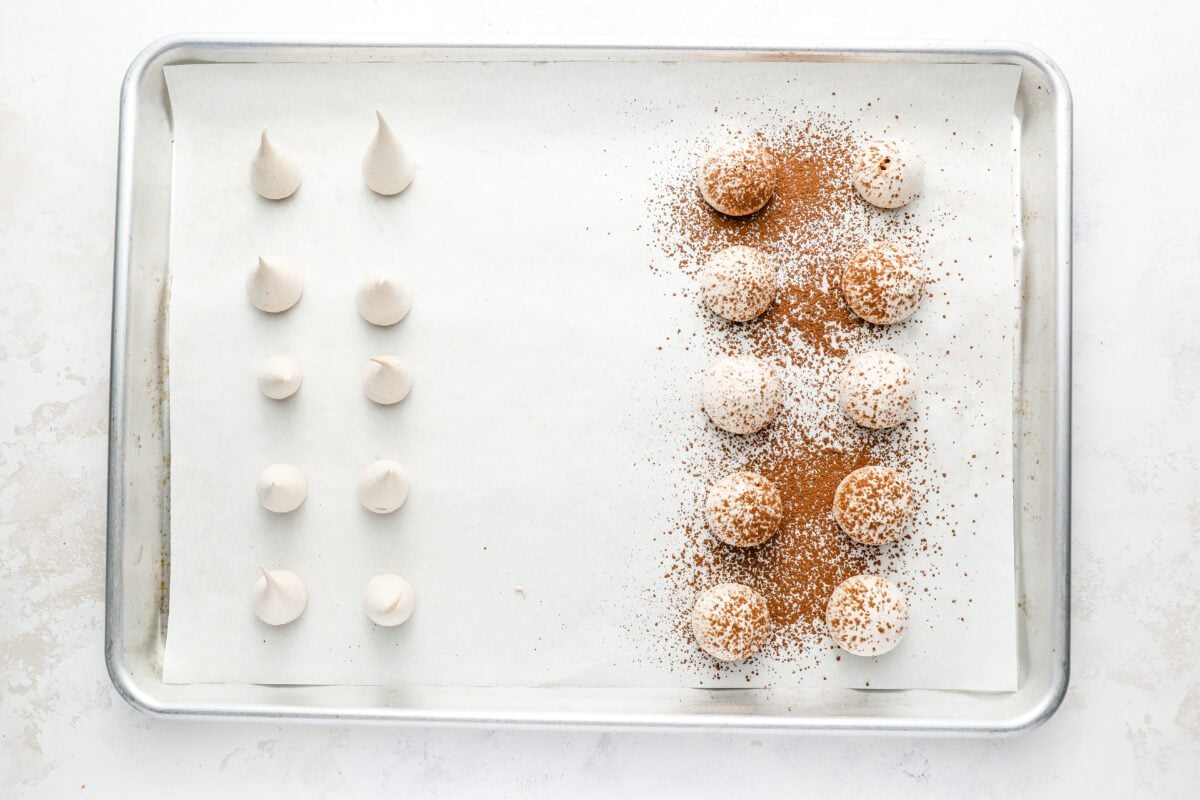 baking sheet with baked mushroom stems and cocoa-powder dusted mushroom caps
