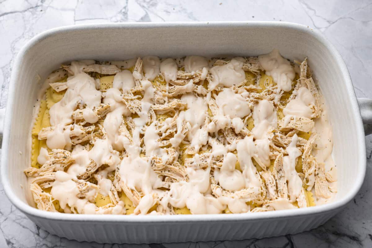 Chicken and sauce layered on top of the ravioli. 