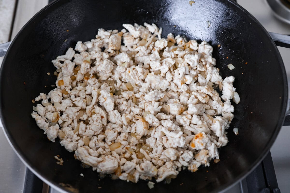 Ground turkey added to the skillet to brown. 