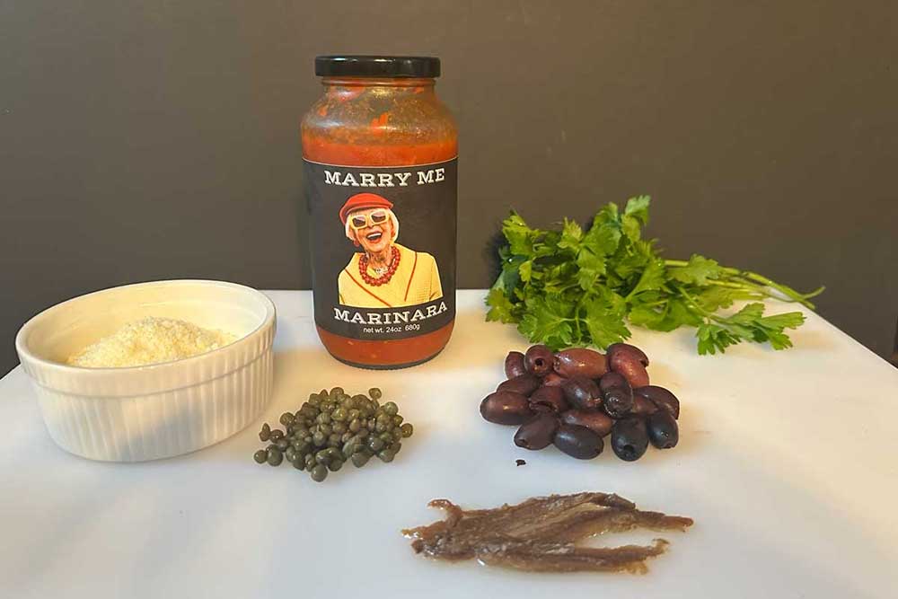 fresh ingredients for romantic pasta dinner including mozzarella basil and parmesan