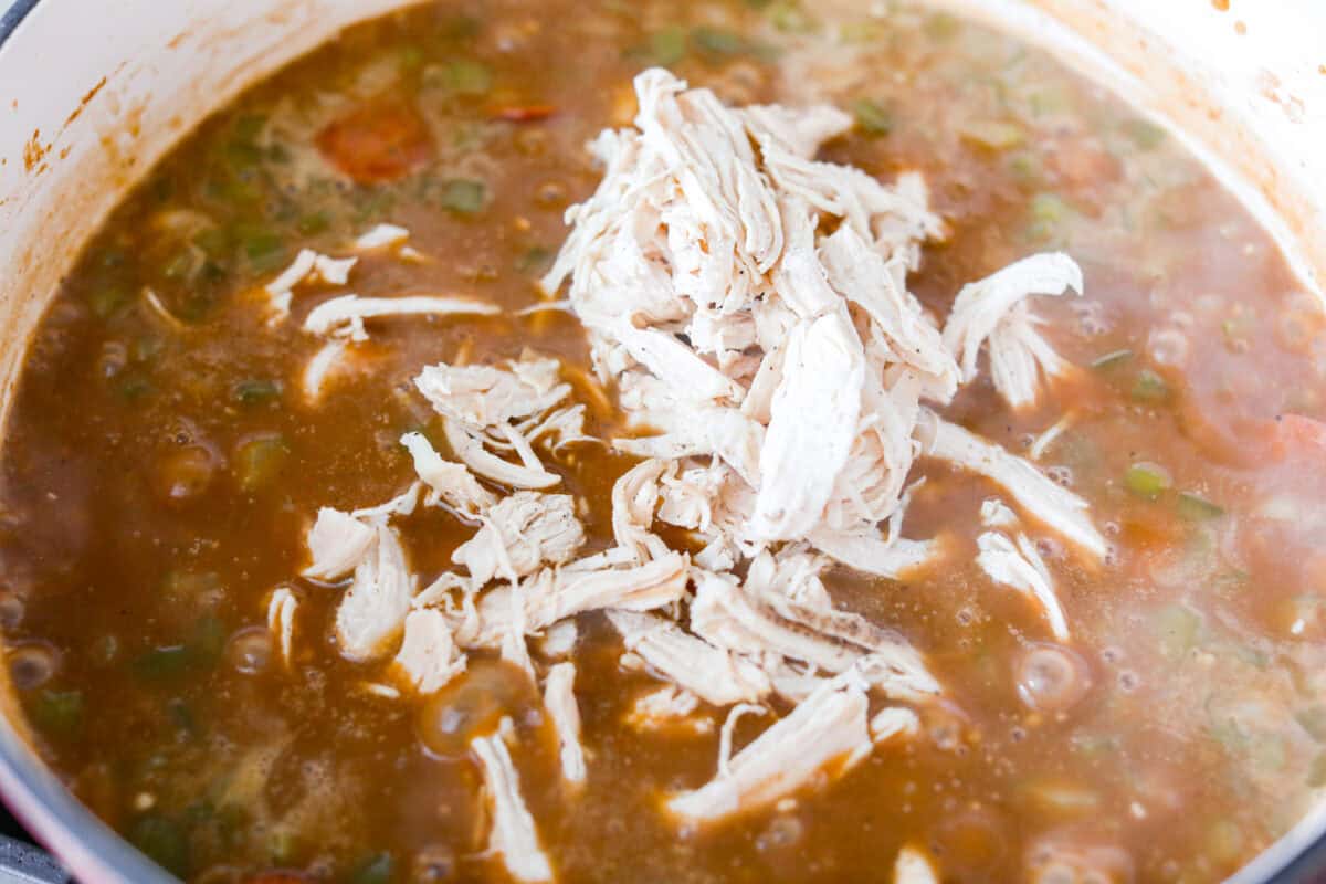 Shredded chicken added to the pot.